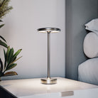 Modern silver table lamp on a white bedside table, minimalist design, LED lighting, sleek metal finish, contemporary bedroom decor.