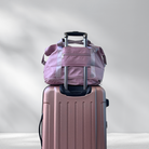 Pink travel luggage set with a rolling suitcase and matching duffel bag, ideal for stylish travel. Durable, lightweight, and perfect for frequent travelers.