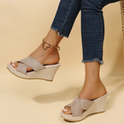 Women's wedge platform sandals with open toe and braided design, casual summer footwear, beige color, paired with jeans.