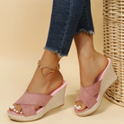 Pink wedge sandals with braided platform, open toe design, paired with frayed hem jeans. Stylish casual footwear for women.