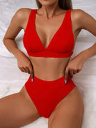 Red bikini set with high-waisted bottoms and a V-neck top, perfect for summer beachwear. Stylish swimwear for women, flattering and trendy design.