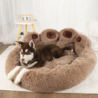 Brown plush dog bed shaped like a paw with a husky puppy, cozy pet furniture.