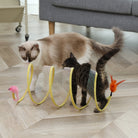 Cats playing with interactive spiral toy featuring a pink mouse and orange feather on wooden floor. Perfect pet entertainment for indoor cats.