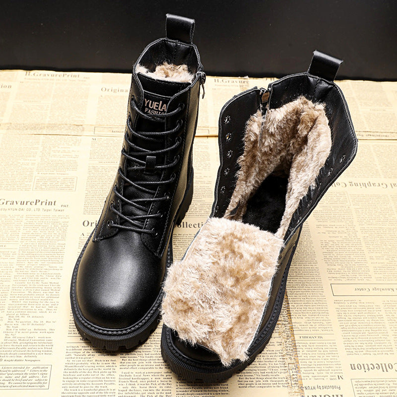 Black leather winter boots with faux fur lining, lace-up design, and durable sole on a vintage newspaper background. Ideal for cold weather fashion.