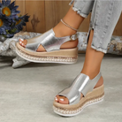 Silver platform sandals with open toe design, ankle strap, and woven espadrille sole. Fashionable summer footwear for women. Casual chic style.