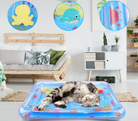 Cat sleeping on a colorful inflatable water mat in a living room; features ocean-themed designs with octopus, whale, and crab toys.