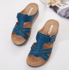 Blue women's wedge sandals with perforated straps and buckle detail, featuring a comfortable cushioned insole, perfect for casual summer wear.