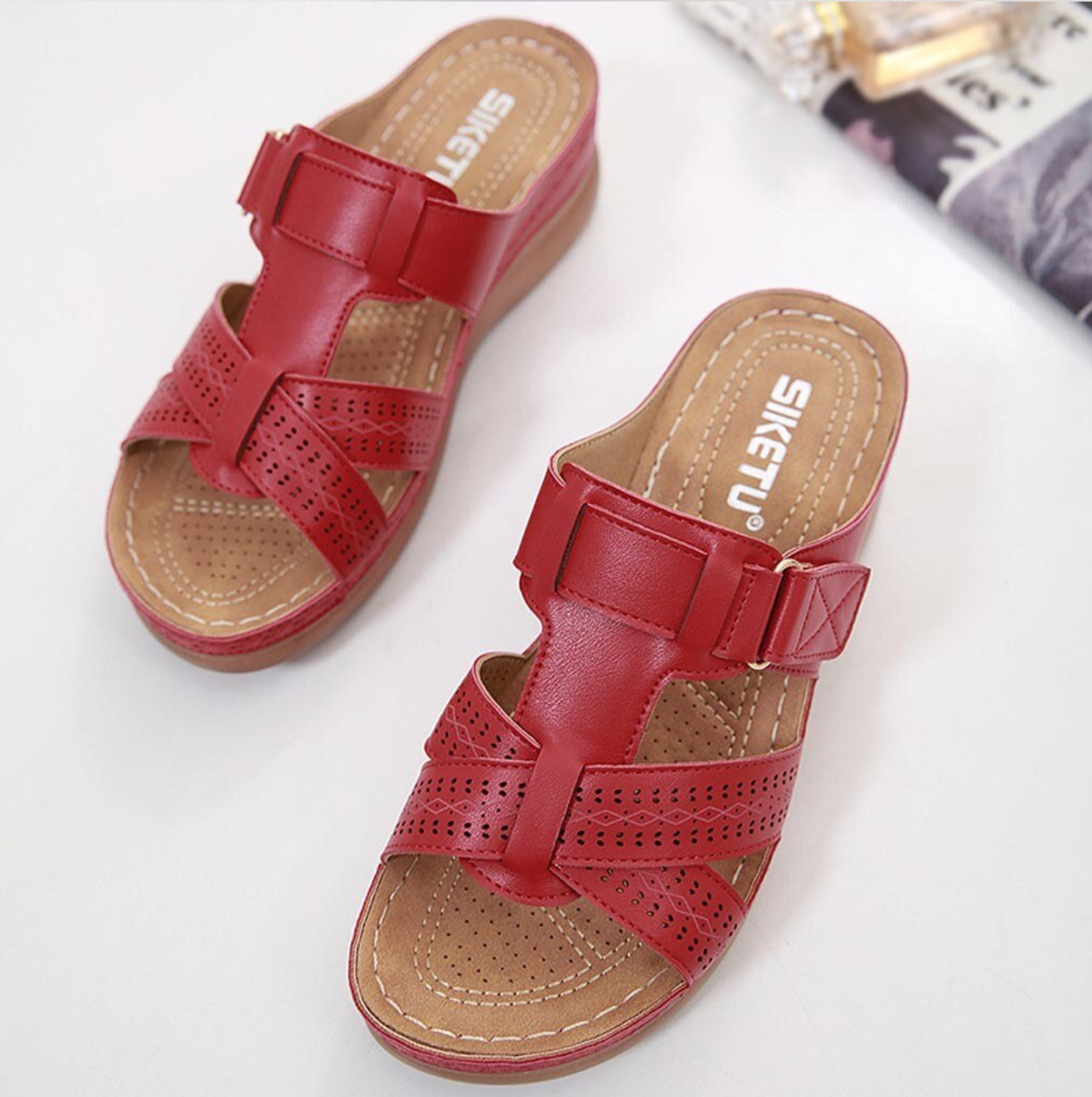 Red women's slip-on sandals with perforated straps and cushioned sole, featuring SIKETU branding. Comfortable summer footwear for casual wear.