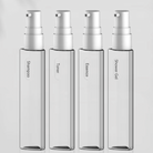 Clear plastic spray bottles labeled Shampoo, Toner, Essence, and Shower Gel, ideal for travel or personal care, minimalist design, white caps.