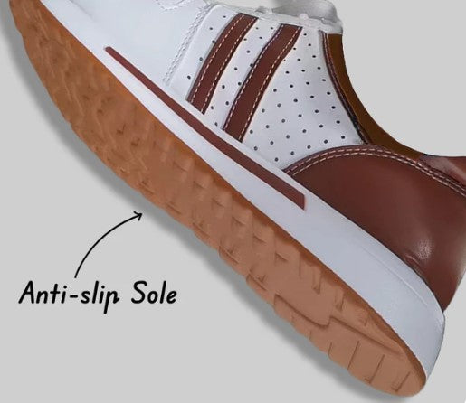 White and brown sneaker with anti-slip sole, featuring perforated design and durable grip. Ideal for sports and casual wear.