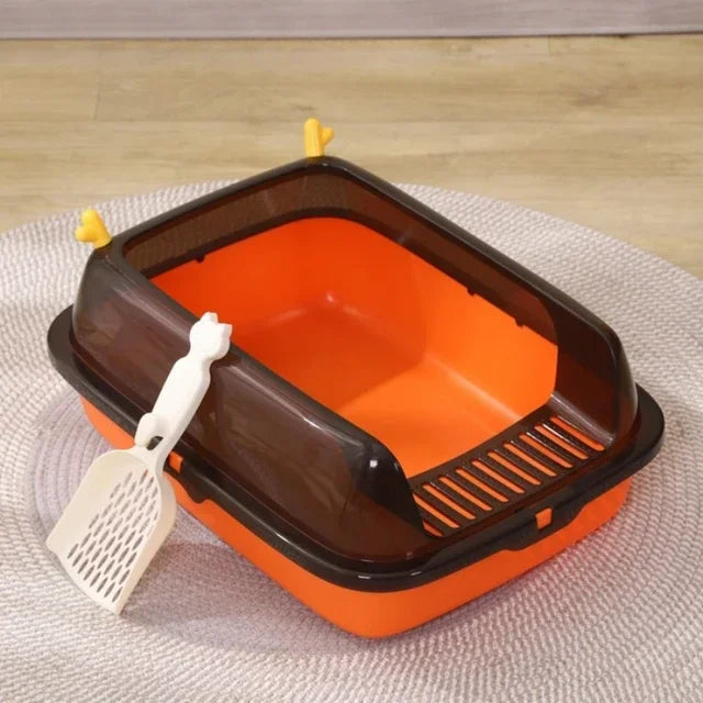 Orange cat litter box with brown lid and white scoop, durable plastic, easy-clean design.