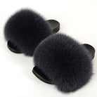 Black fluffy fur slides on a white background, featuring soft faux fur and comfortable slip-on design. Perfect for cozy indoor wear and fashion-forward style.