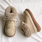 Beige fur-lined winter boots with thick soles on white background, featuring lace-up design and plush interior for warmth and comfort.