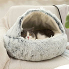 Gray plush cat bed with cozy cave design, featuring a relaxed cat inside, perfect for pet comfort.