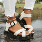 Women's white Roman platform sandals with black soles, adjustable buckle, and casual summer style, perfect for outdoor fashion in 2023.