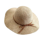 Wide-brimmed straw sun hat for women with brown ribbon, perfect for summer beach outings, offering stylish sun protection and casual elegance.
