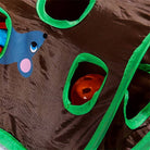 Interactive cat toy with green-trimmed holes, featuring a blue mouse design and an orange ball inside, perfect for playful pet engagement.