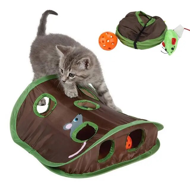 Kitten playing with interactive cat toy featuring green and brown tunnel, orange ball, and plush mouse. Perfect for pet entertainment and exercise.