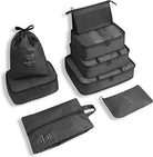 Set of black travel packing cubes and bags, including various sizes for organized luggage storage. Ideal for efficient packing and travel organization.