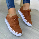 Women's brown lace-up sneakers with white soles, featuring a casual and versatile design. Perfect for spring fashion and everyday wear.