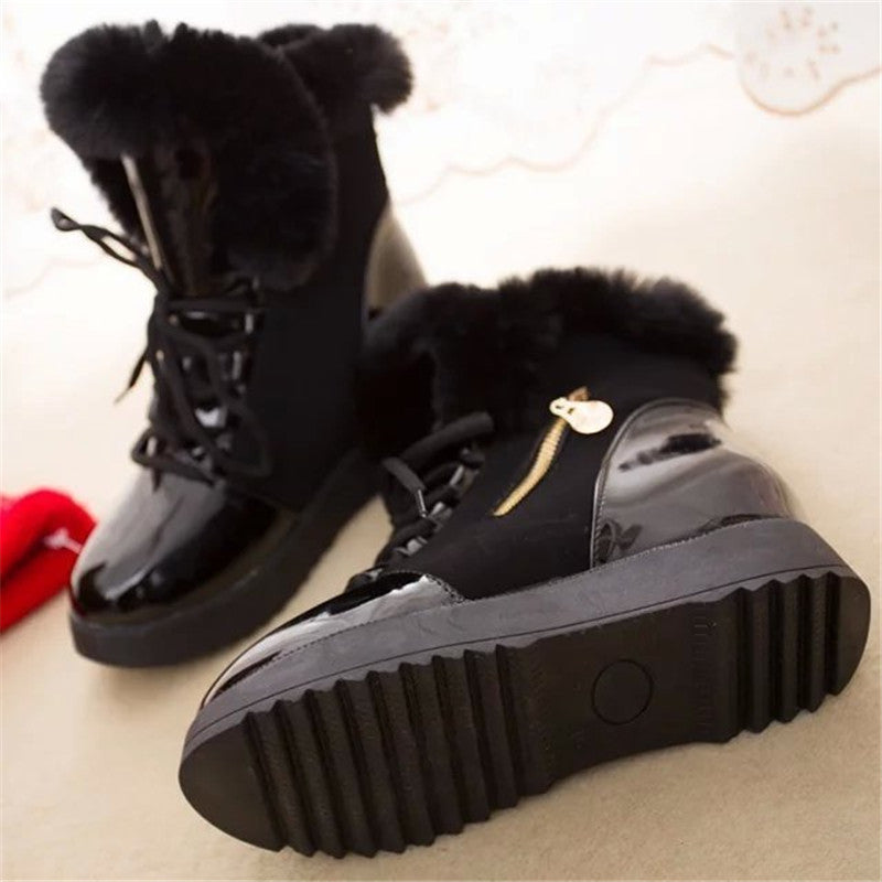 Black women's winter snow boots with platform soles, thick fur lining, and lace-up design. Stylish, warm ankle boots ideal for cold weather.