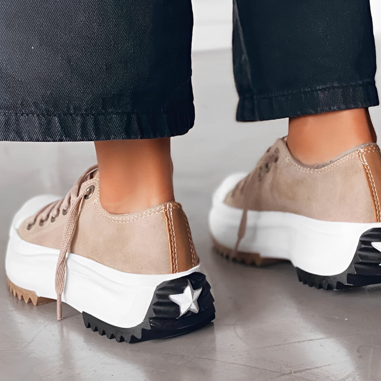 Stylish beige platform sneakers with star detail on the heel, paired with black pants. Trendy women's footwear, casual fashion, chunky sole shoes.