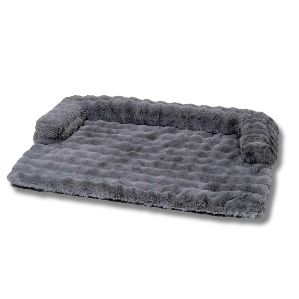 Gray plush dog bed with raised bolster sides, soft faux fur surface, and non-slip bottom. Ideal for medium to large pets. Comfortable pet bedding.