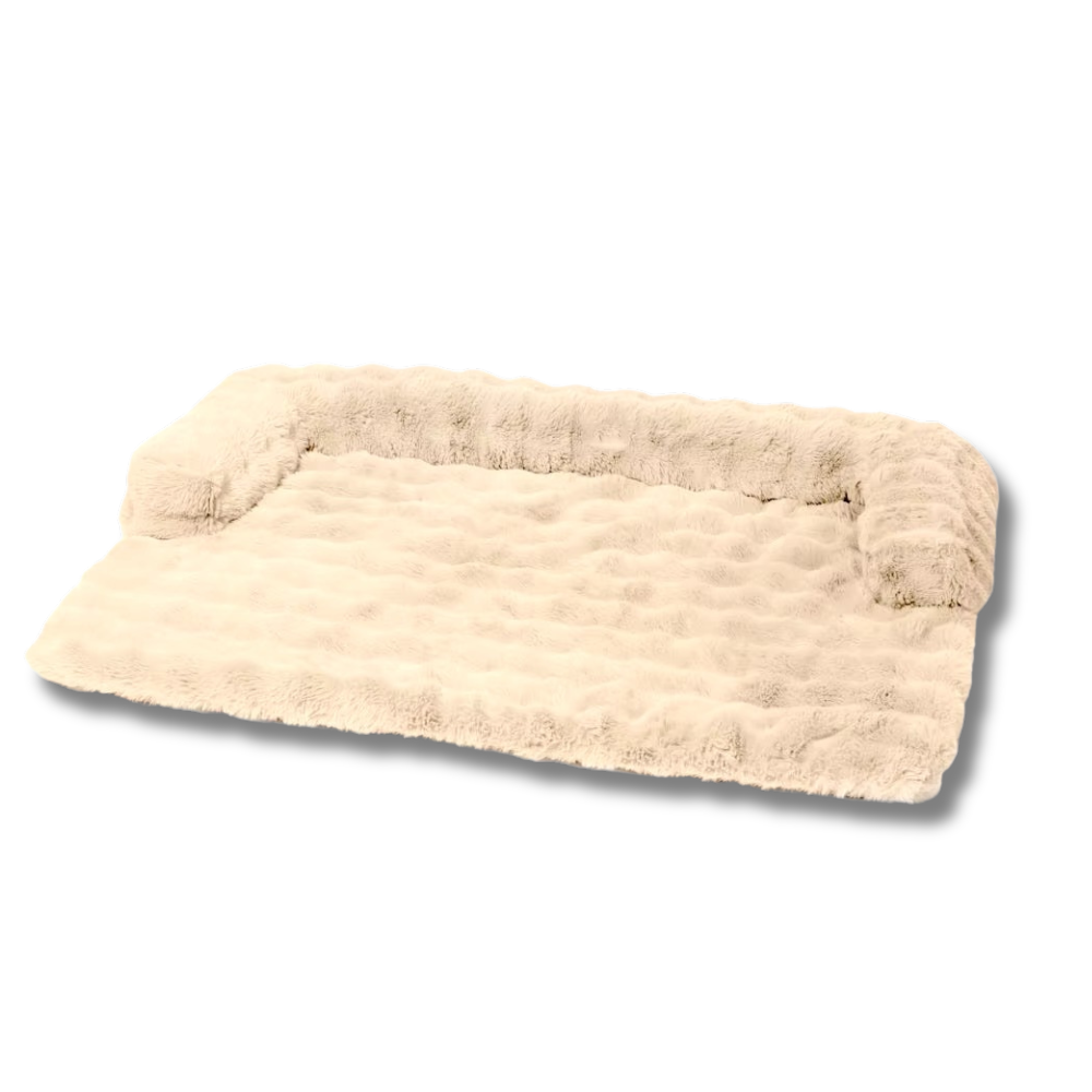 Plush beige dog bed with raised bolster sides, soft faux fur surface, ideal for pet comfort and support. Perfect for small to medium-sized dogs.