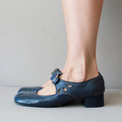 Women's blue leather loafers with buckle, low block heel, and cutout design. Stylish, breathable, non-slip shoes ideal for business or casual wear.