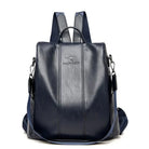 Navy blue leather backpack with adjustable straps, front logo, and sleek design. Perfect for travel, school, or work. Durable and stylish accessory.