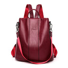 Red leather backpack with adjustable straps, sleek design, and metal clasps. Perfect for fashion-forward individuals seeking stylish, durable bags.