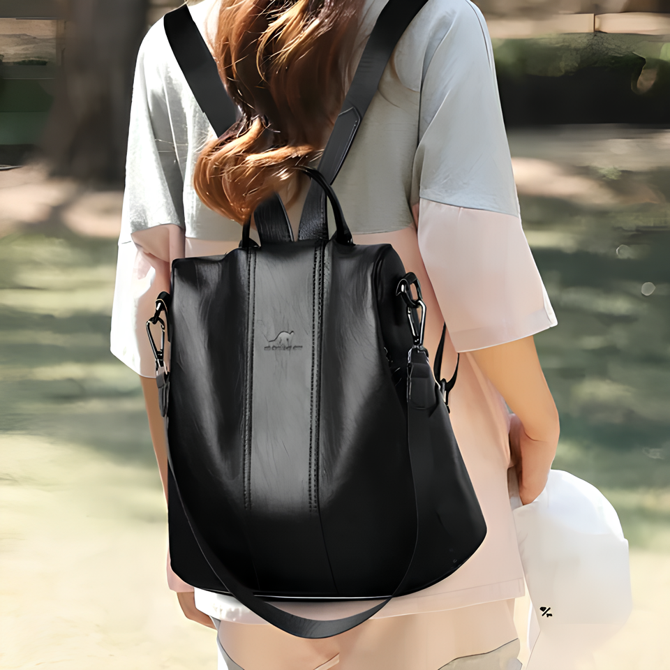 Stylish black leather backpack with adjustable straps, worn by a woman in a casual outfit. Perfect for travel, school, or work. Fashionable and versatile.