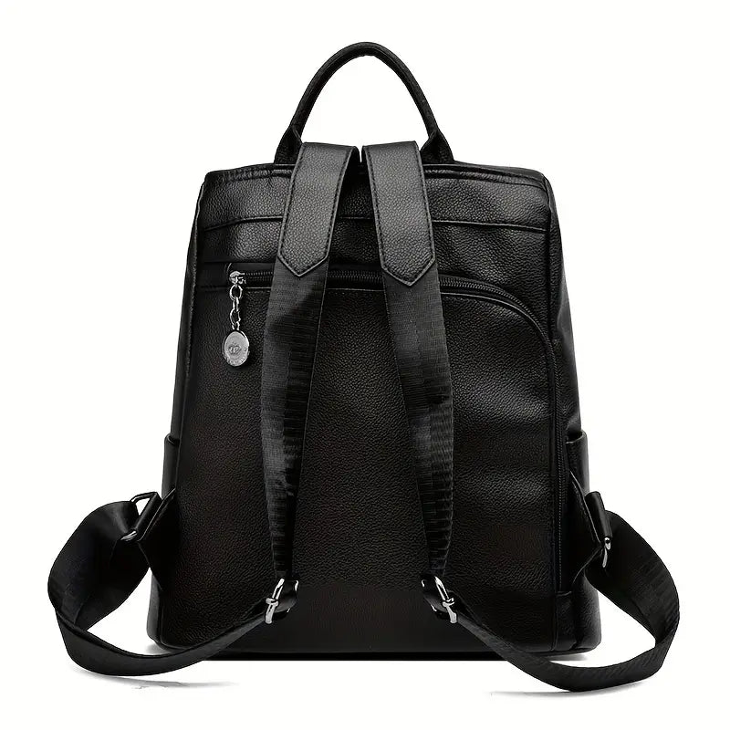 Black leather backpack with adjustable straps, front zipper pocket, and silver charm. Stylish and functional for travel, school, or work.