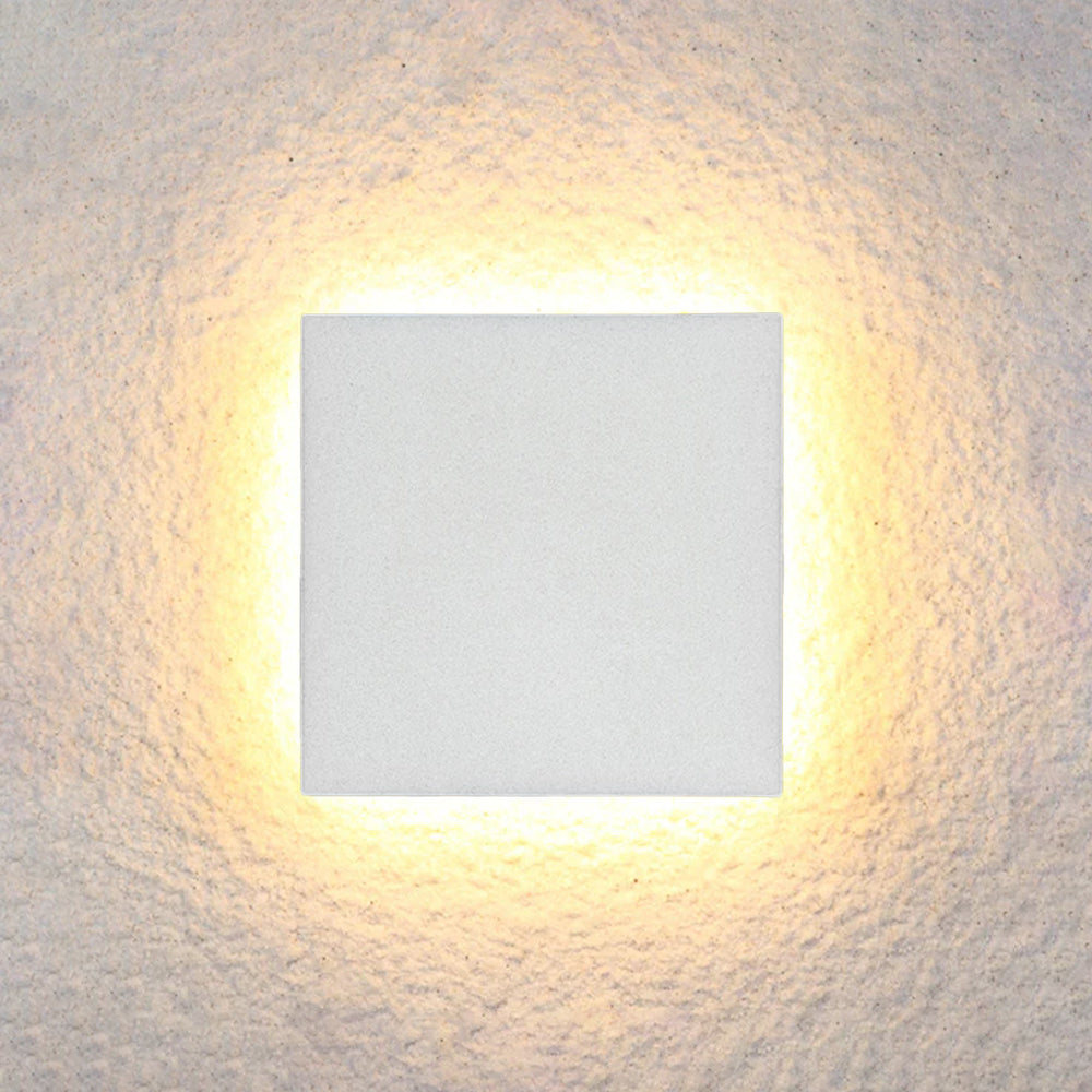 Square LED wall light with warm glow, mounted on textured surface. Modern minimalist design, energy-efficient lighting, ideal for home decor.