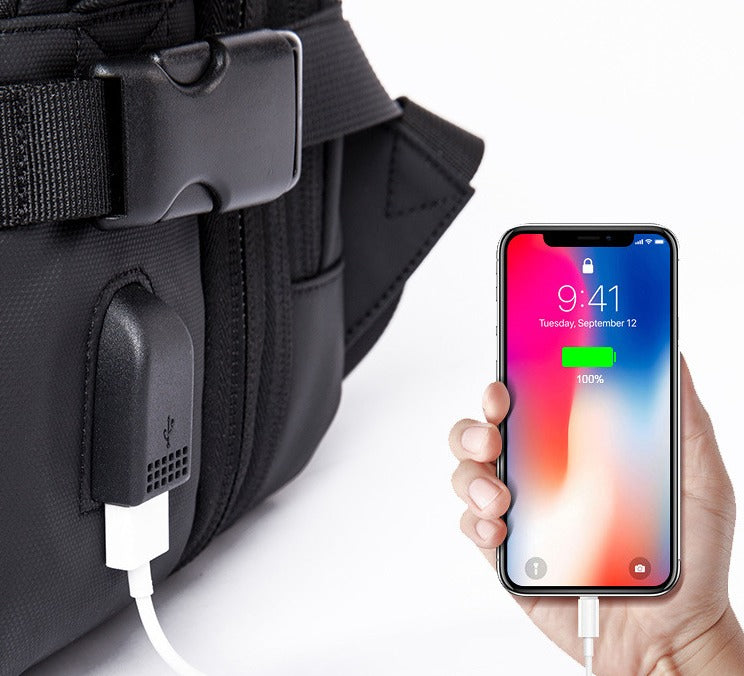 Smartphone charging via USB port on black backpack; portable power bank feature, mobile device, travel accessory, convenient on-the-go charging.