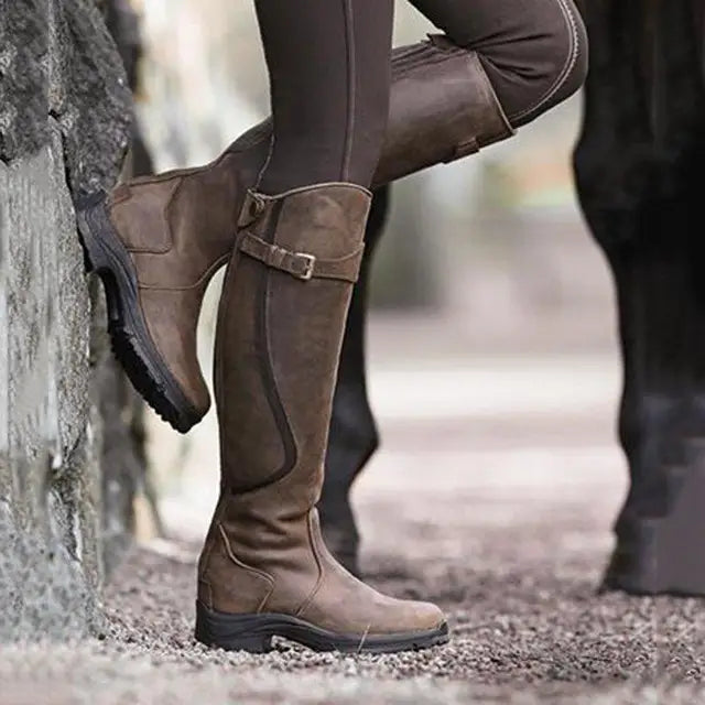 Women's brown PU leather knee-high boots with zipper and buckle detail, retro casual design, low heel, fashion footwear for ladies.