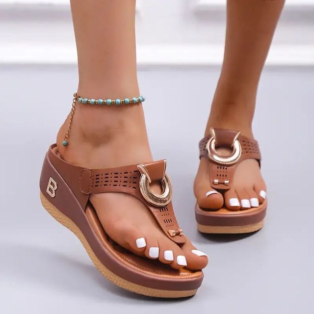 Women's brown wedge sandals with open toe design, featuring decorative gold ring and ankle bracelet. Perfect for summer beachwear and casual outings.