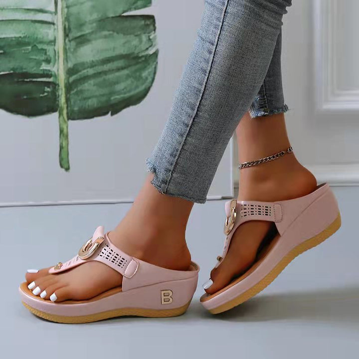 Women's pink wedge sandals with open toe design, featuring a decorative buckle and comfortable sole. Ideal for summer beachwear and casual outings.