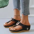 Women's black wedge sandals with open toe design, gold buckle, and comfortable sole. Perfect for summer beachwear and casual outings.