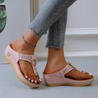 Pink women's summer sandals with open toe and wedge heel, featuring a comfortable design. Ideal for beachwear and casual outings.