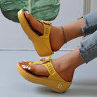 Yellow women's summer sandals with open toe, wedge heel, and decorative buckle. Comfortable beach flip-flops, perfect for casual wear.