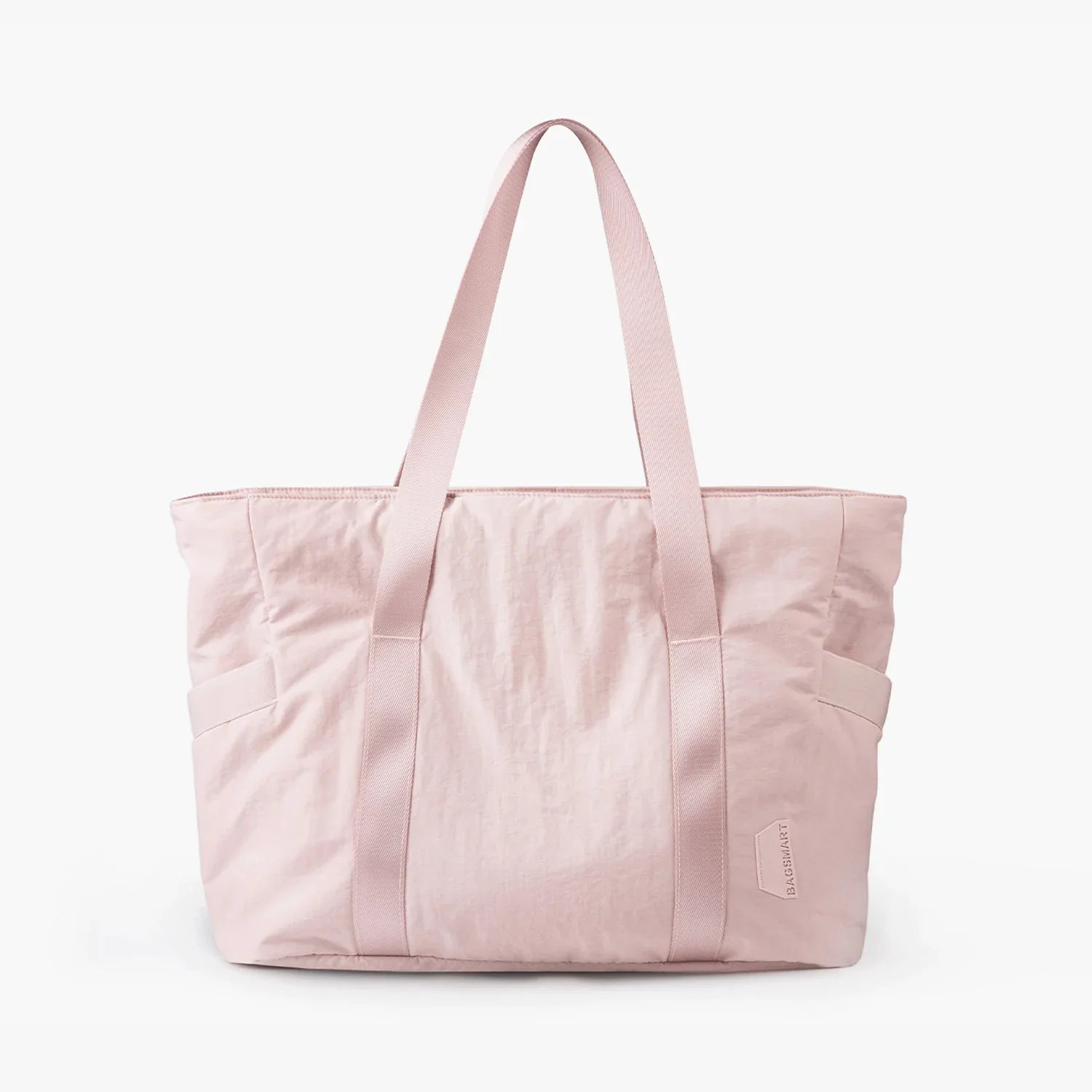 Pink tote bag with dual handles, spacious design, and subtle side pockets. Ideal for everyday use. Fashionable and practical accessory.