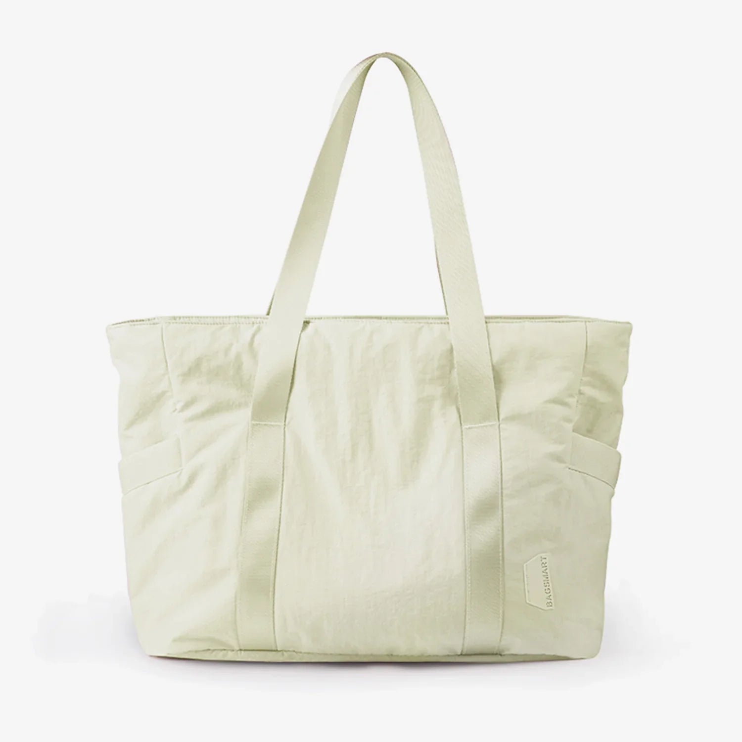 Light green tote bag with dual handles, minimalist design, and side pockets. Perfect for casual outings. Eco-friendly fashion accessory.