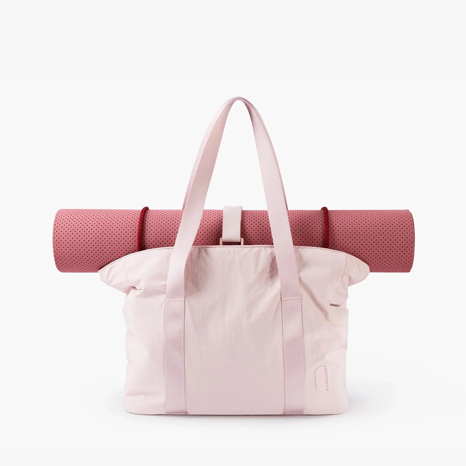 Pink tote bag with attached yoga mat, featuring durable straps and minimalist design. Perfect for gym, travel, or daily use. Stylish and functional.