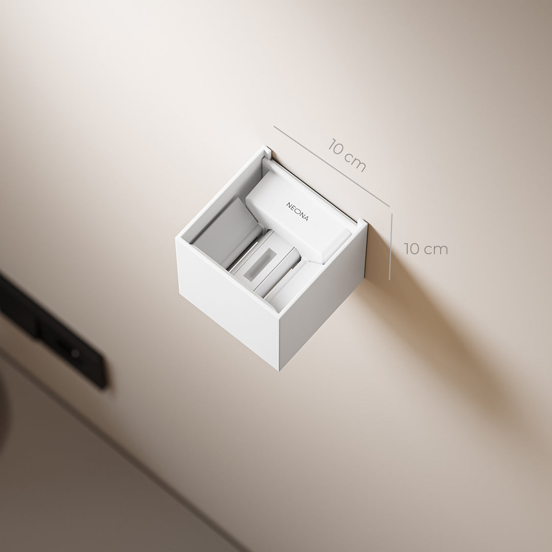 Wall-mounted white tissue dispenser with sleek design, measuring 10x10 cm, ideal for modern bathrooms. Neat and compact storage solution.