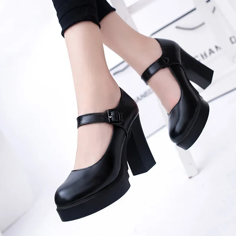 Black Mary Jane platform heels with ankle strap, chunky block heel design, worn by a model. Perfect for fashion-forward women's footwear trends.