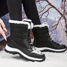 Black winter snow boots with white fur lining, rugged soles, and lace-up design, perfect for outdoor activities in snowy conditions.