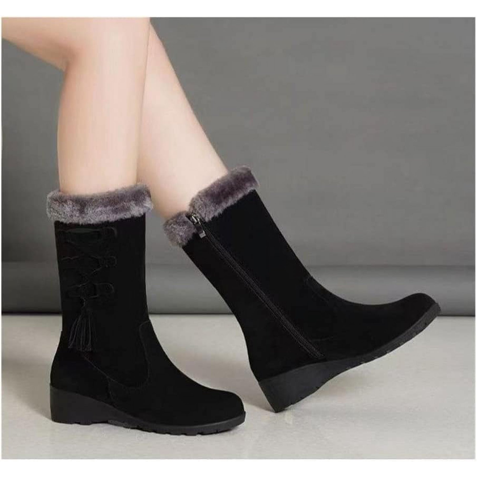 Black suede winter boots with faux fur trim, side zipper, and wedge heel. Stylish women's footwear for cold weather. Comfortable and trendy design.