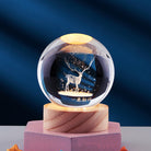 Crystal ball with illuminated deer design, resting on a wooden base. Elegant home decor, perfect for gifts and enhancing interior aesthetics.