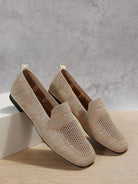 Beige woven loafers on display against a gray background, featuring a breathable design and slip-on style. Perfect for casual and formal wear.